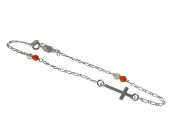 

Silver anklet programmed chain and cross lying and tupis color