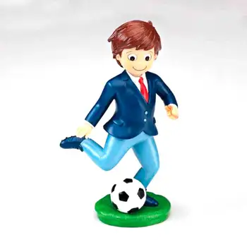 

CAKE FIGURE FOR FIRST COMMUNION. CHILD PLAYING FOOTBALL. DETAIL FOR FIRST COMMUNION CAKE