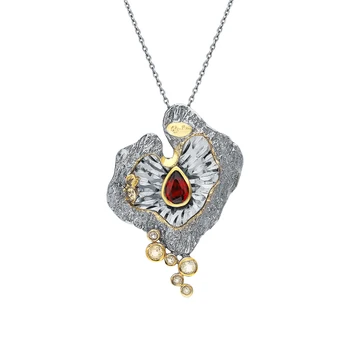 

Silver brooch with garnet and citrine sunlight